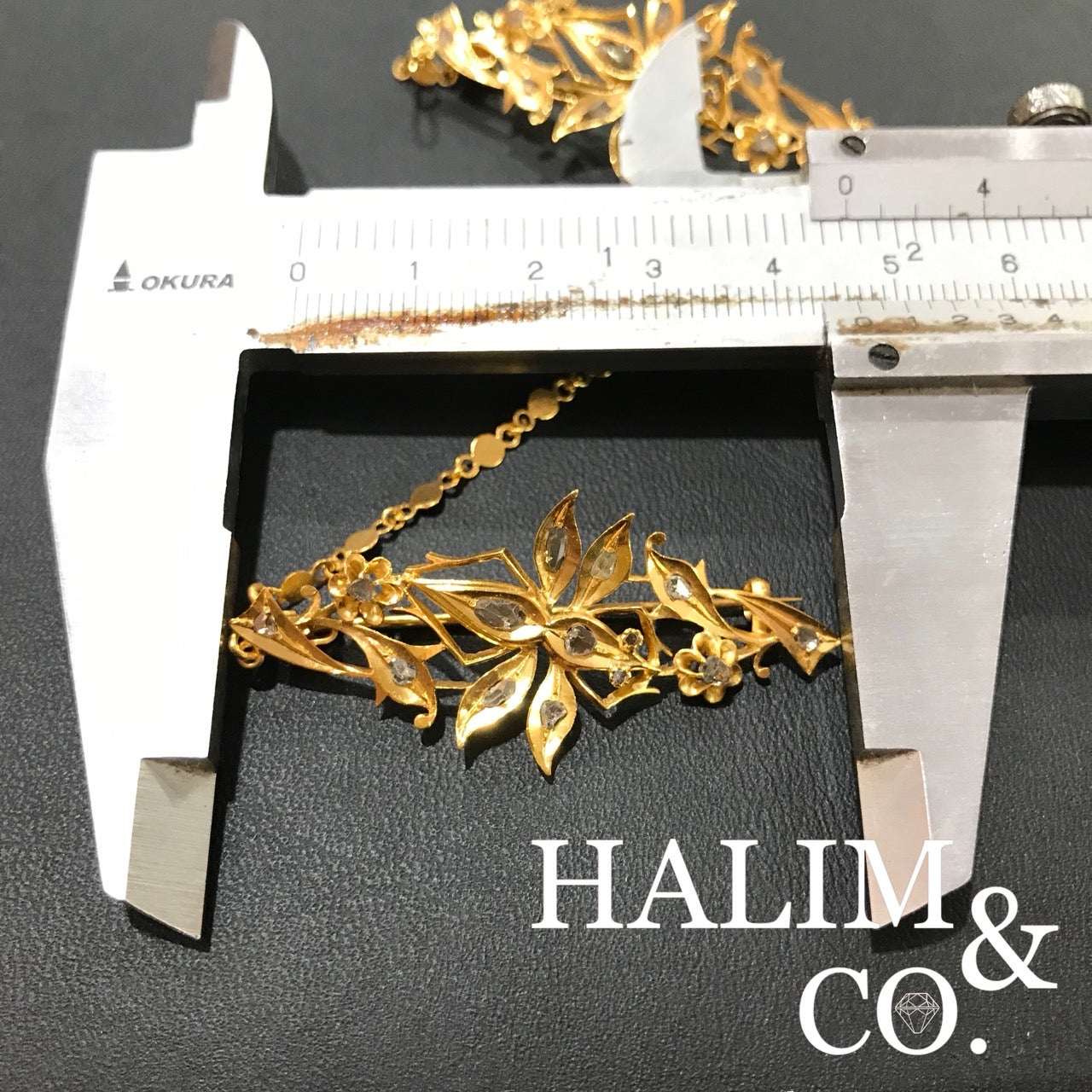 A gorgeous set of three antique gold brooches set with polki diamonds with patterned chains.