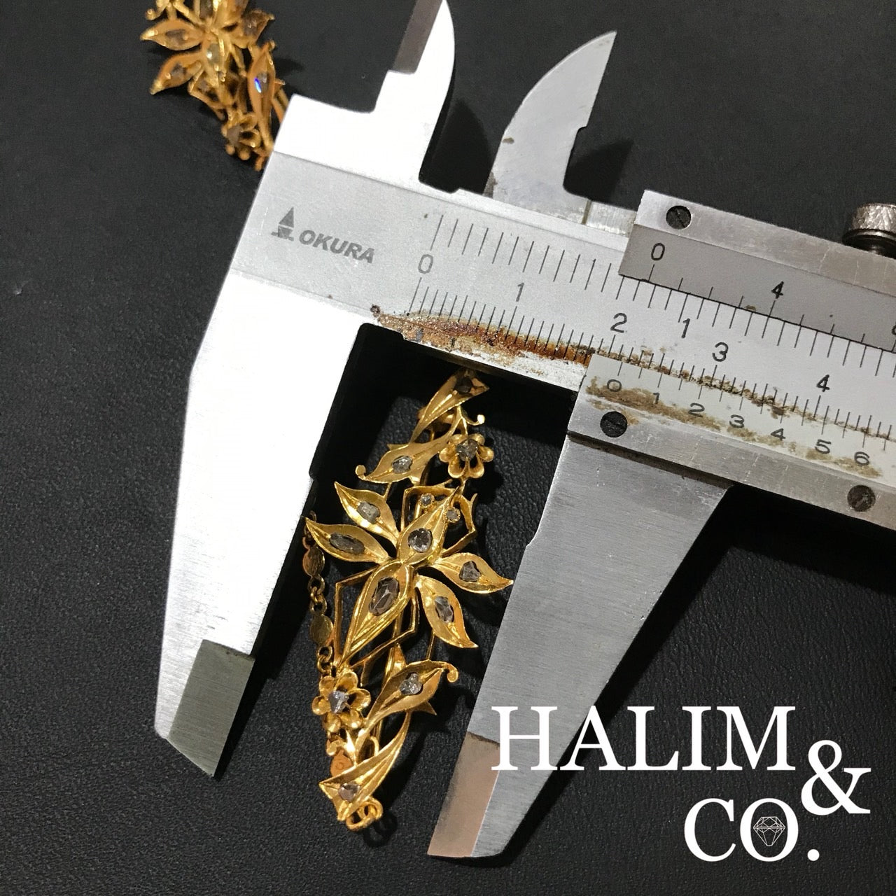 A gorgeous set of three antique gold brooches set with polki diamonds with patterned chains.
