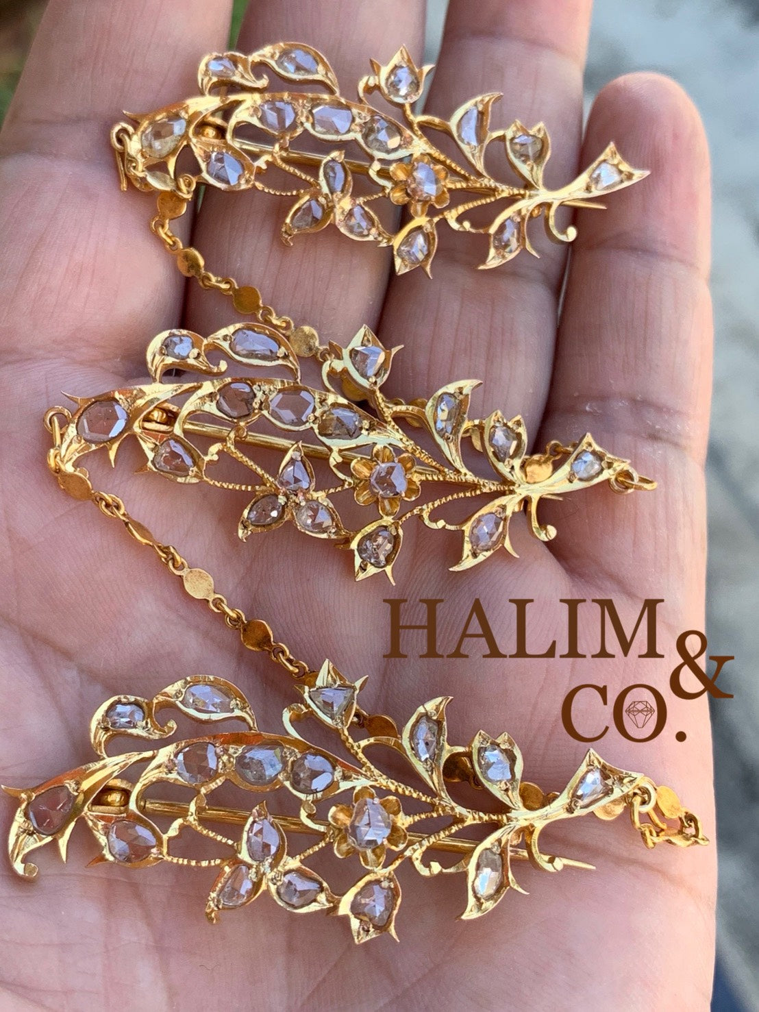 A gorgeous set of three antique gold brooches set with rose cut diamonds with patterned chains.