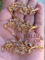 A gorgeous set of three antique gold brooches set with rose cut diamonds with patterned chains.