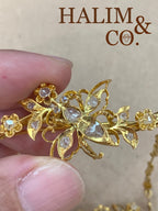 A gorgeous set of three antique gold brooches set with rose cut diamonds with patterned chains.