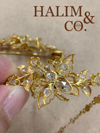 A gorgeous set of three antique gold brooches set with rose cut diamonds with patterned chains.