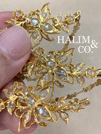 A gorgeous set of three antique gold brooches set with rose cut diamonds with patterned chains.