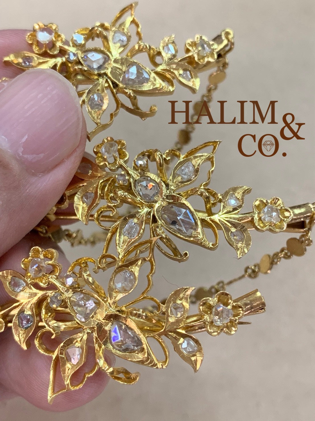 A gorgeous set of three antique gold brooches set with rose cut diamonds with patterned chains.